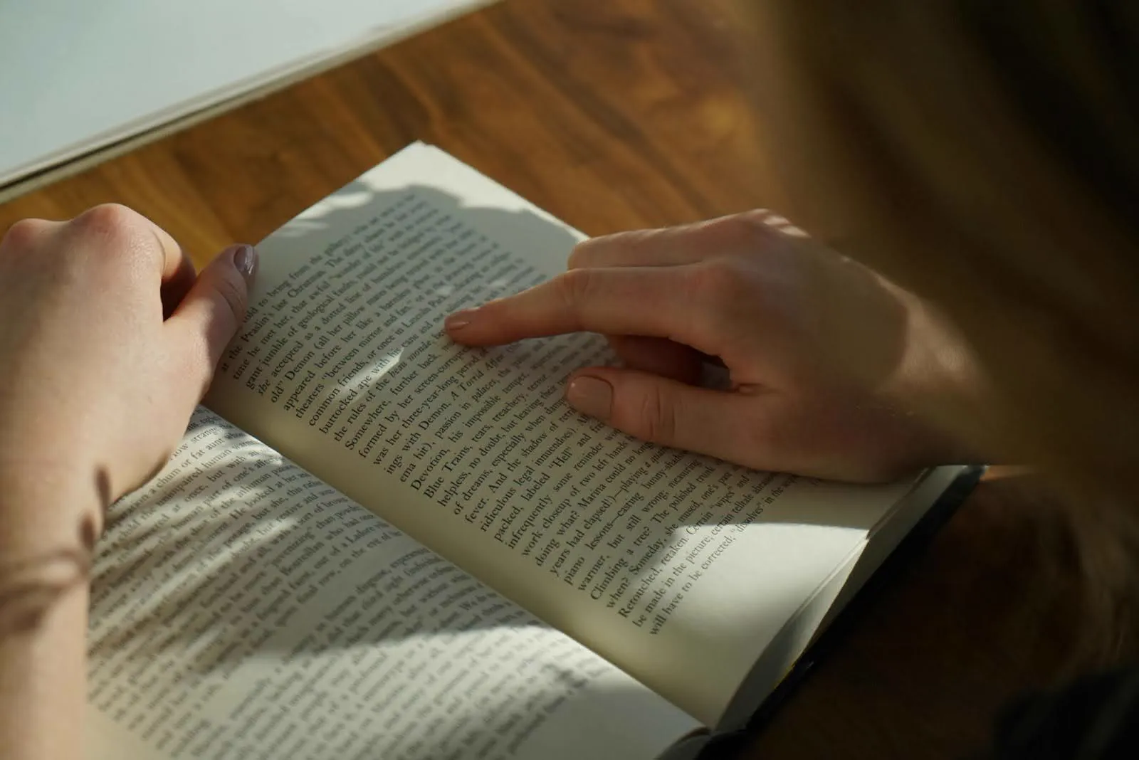 Close-up of hands holding an open book