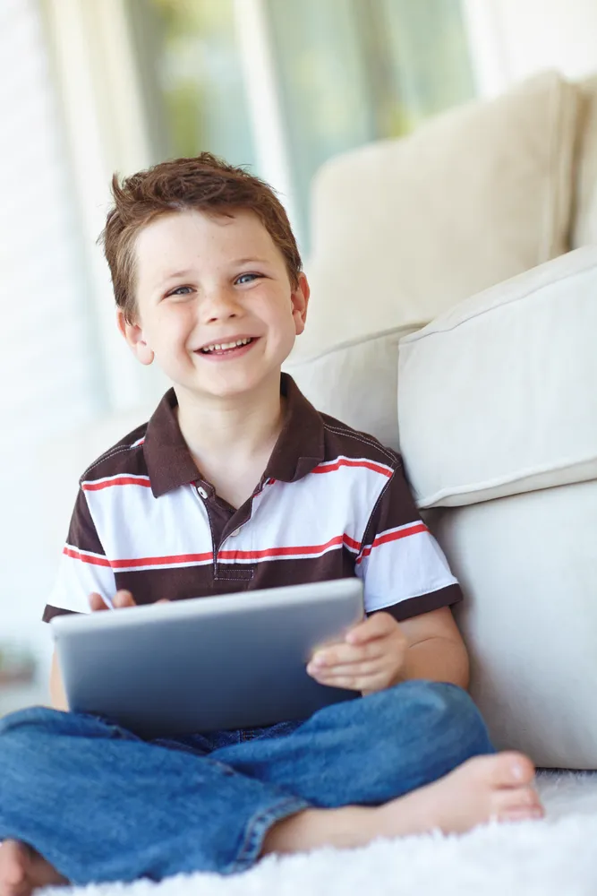 Smiling boy holding tablet