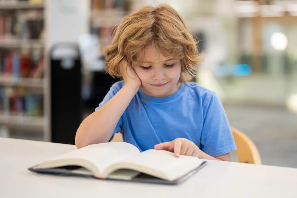 A child practicing reading strategies for kids with dyslexia.