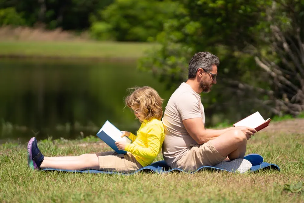 A father implementing dyslexia reading strategies with their child.