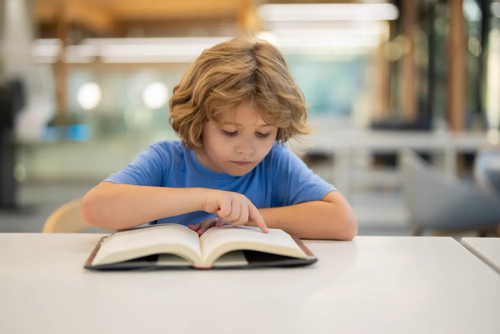 A kid practicing questioning techniques for reading comprehension.